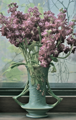 Beautiful ceramic vase with purple flowers