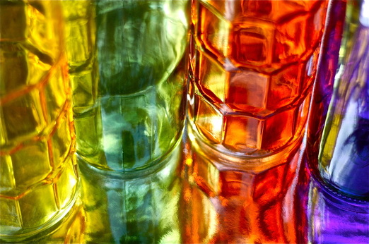 Colored glass bottles and their reflections